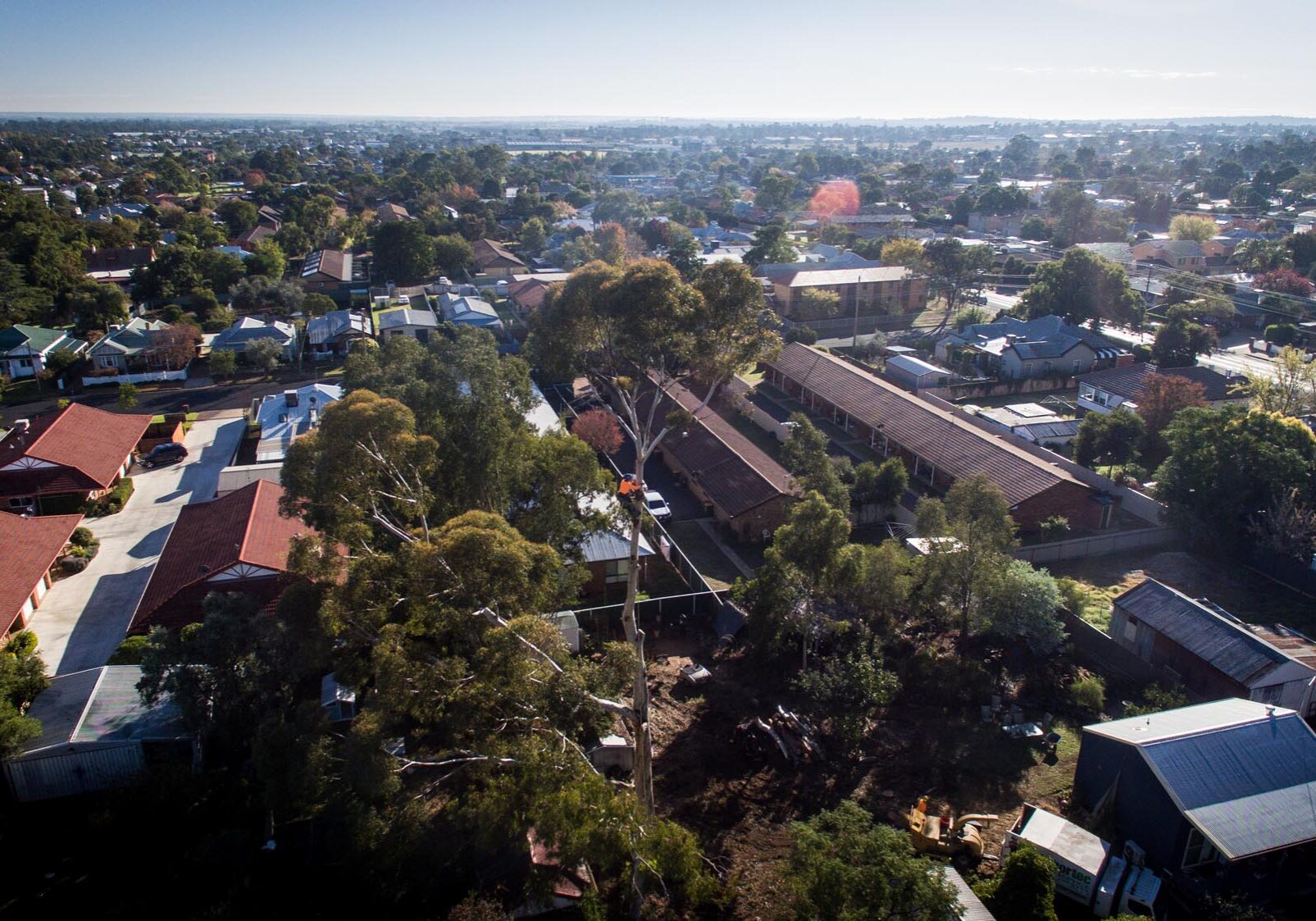 An aerial view of a town with houses and trees.